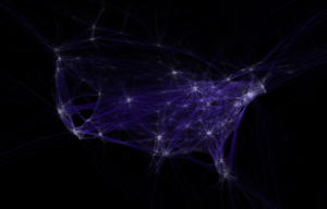 A black background with bluish lines tracing the routes of commercial airline traffic: there are so many routes that the shape of the USA is clearly visible. Major cities appear as bright spots of connecting lines.